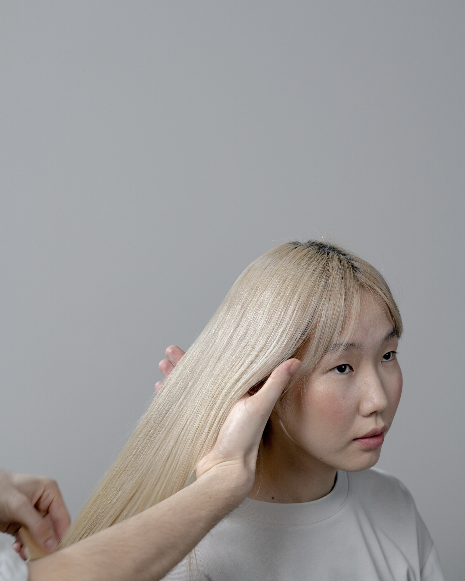 Photo of a Woman Getting Her Hair Styled